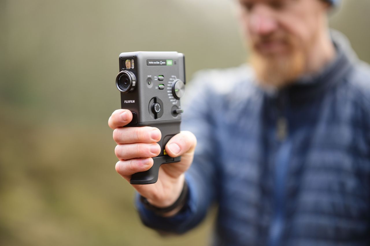 Viltrox AF 85mm F1.4 Pro lens sample gallery: man holding the Fujifilm Instax Mini Evo Cinema camera