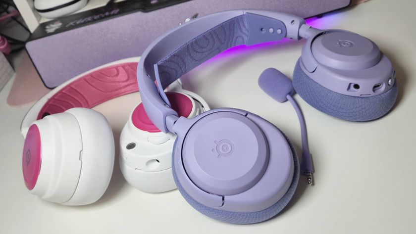 SteelSeries Arctis Nova 3 wireless headsets in purple and white on a white desk