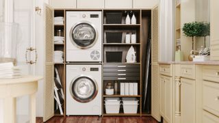 a tumble dryer and washing machine in a modern, neutral laundry room