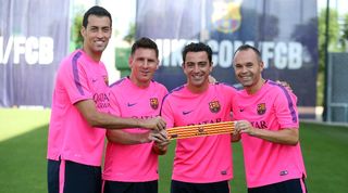 Barcelona captains Sergio Busquets, Lionel Messi, Xavi Hernandez and Andres Iniesta pose at the club's training ground in August 2014.
