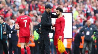 Jurgen Klopp consoles Mohamed Salah after Liverpool narrowly miss out on the Premier League title.