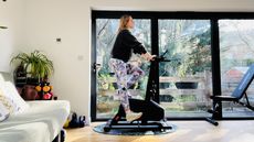 Woman on exercise bike in domestic setting