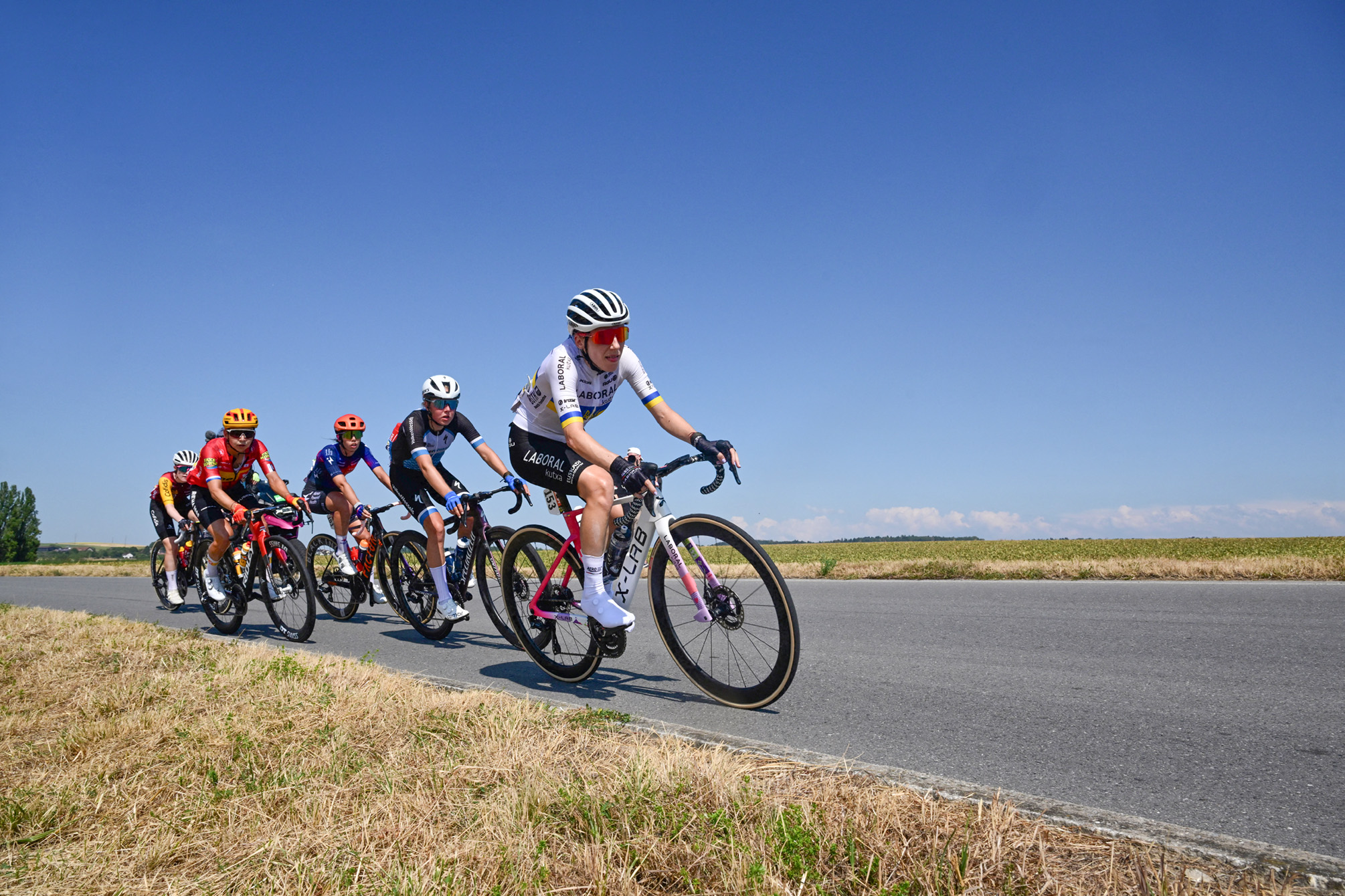 Riders in a breakaway including Laboral Kutxa-Fundacion Euskadi's Ukrainian rider Yuliia Biriukova (R), VolkerWessels Cycling Team's Dutch rider Eline Jansen (2nd R) and Human Powered Health's Italian rider Carlotta Cipressi (3rd R) compete during the second (out of 9) stage of the fifth edition of the Women's Tour de France cycling race, 147.9 km from Aigle to Geneva, in Aigle on August 2, 2026. (Photo by Nicolas TUCAT / AFP via Getty Images)