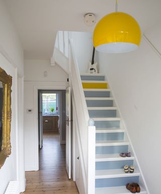 hallway area with white walls and bright yellow statement light