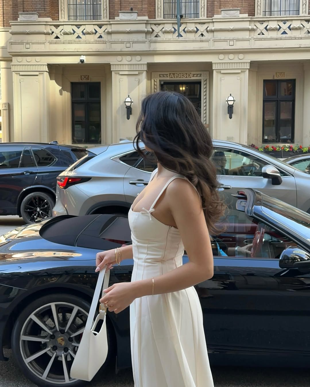 Mobina Peiman poses in a white dress with delicate bow details on the straps
