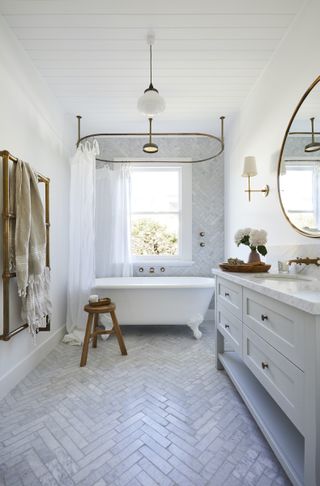 freestanding bath with chevron marble floor tiles in bathroom