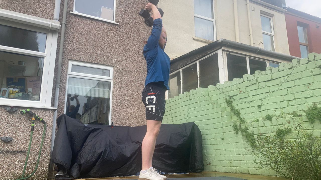 Fit&amp;Well fitness writer Harry Bullmore demonstrating an overhead triceps extension