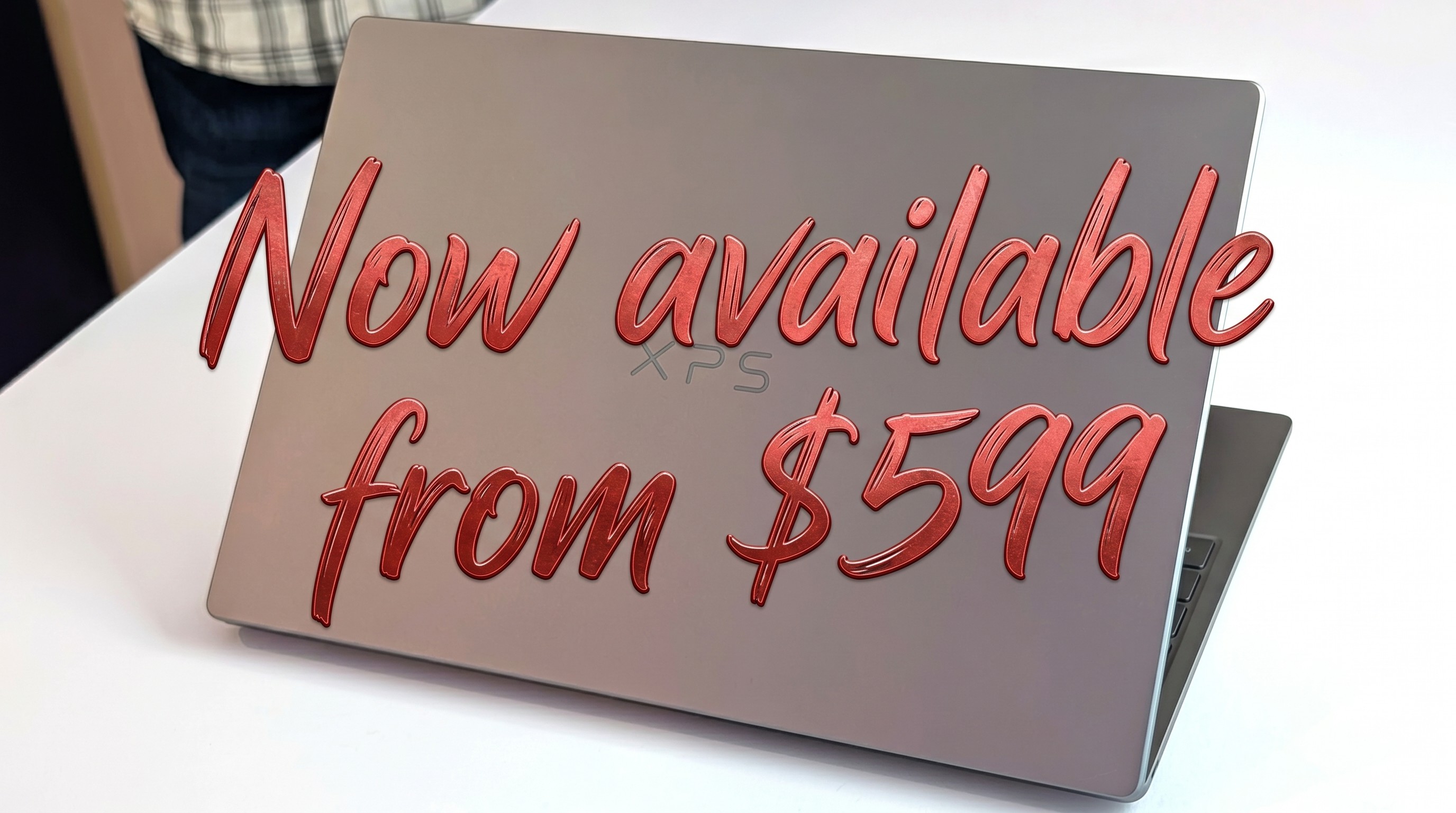 Open XPS 13 laptop with text "Now available from $599" overlaid in red cursive.