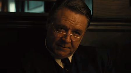 A close up of Russell Crowe looking over his glasses in Unabomber