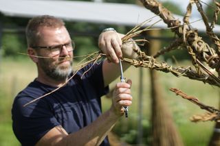 Des Gillan working on his willow sculpture in the Willow Weaving Corner.