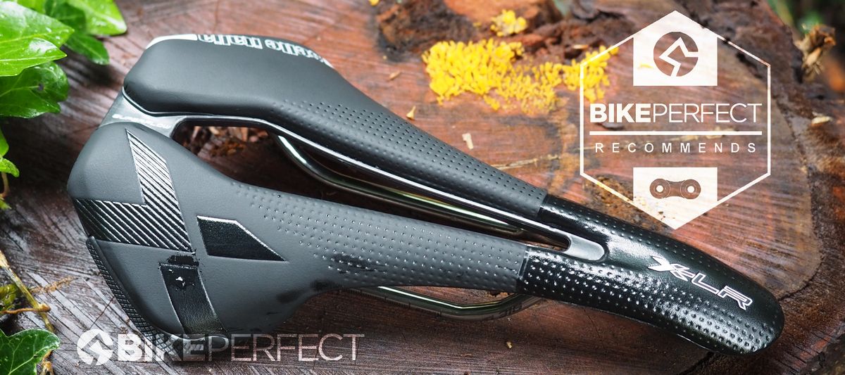 A top-down view of the black Selle Italia X-LR TI316 Superflow saddle, with central cut-out, black X on the right flank and shiny gloss finish on the nose