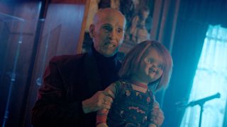 John Waters as Wendell Wilkins holding a Good Guys doll in Chucky Season 3