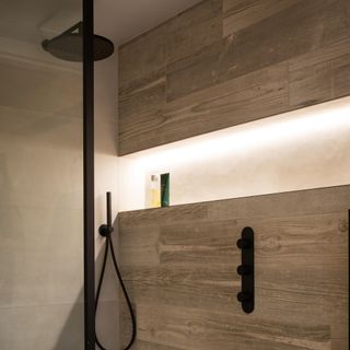 wood shower wall with black shower head