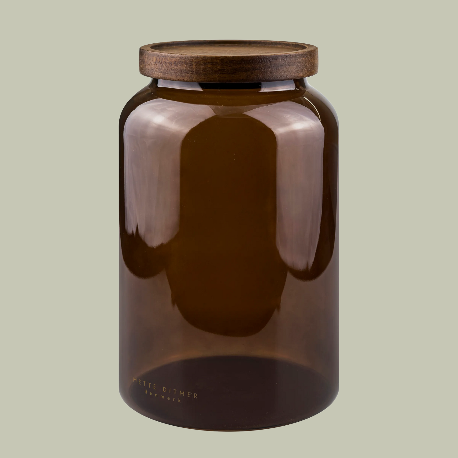 A brown glass jar with a wood lid