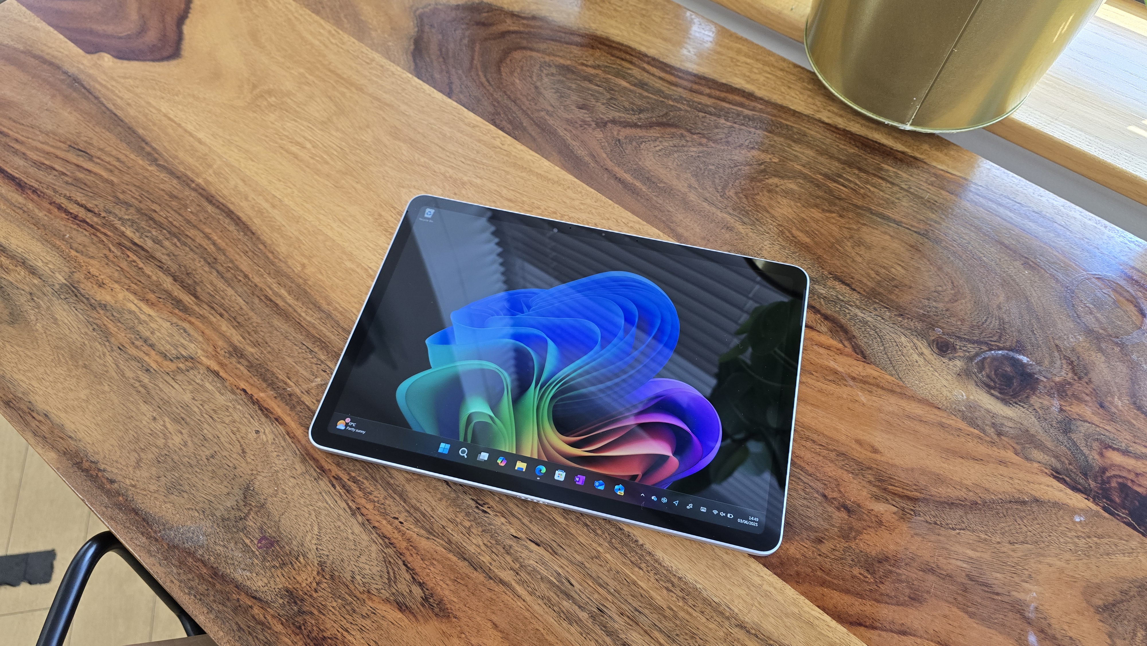 Microsoft Surface Pro 12 tablet on wooden table in relaxed cafe