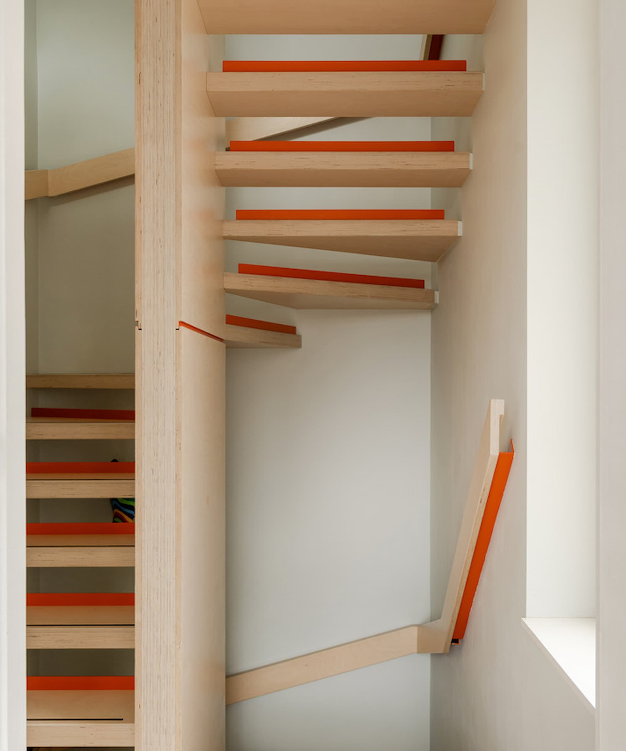 A wooden staircase that goes up three stories