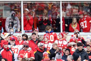 Taylor Swift in the stands at a Chiefs game wearing a vintage Chiefs sweater