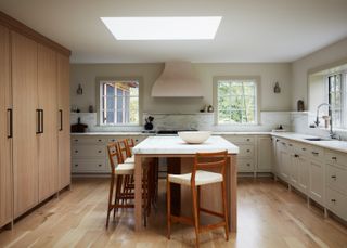 a modern kitchen with an island and skylight