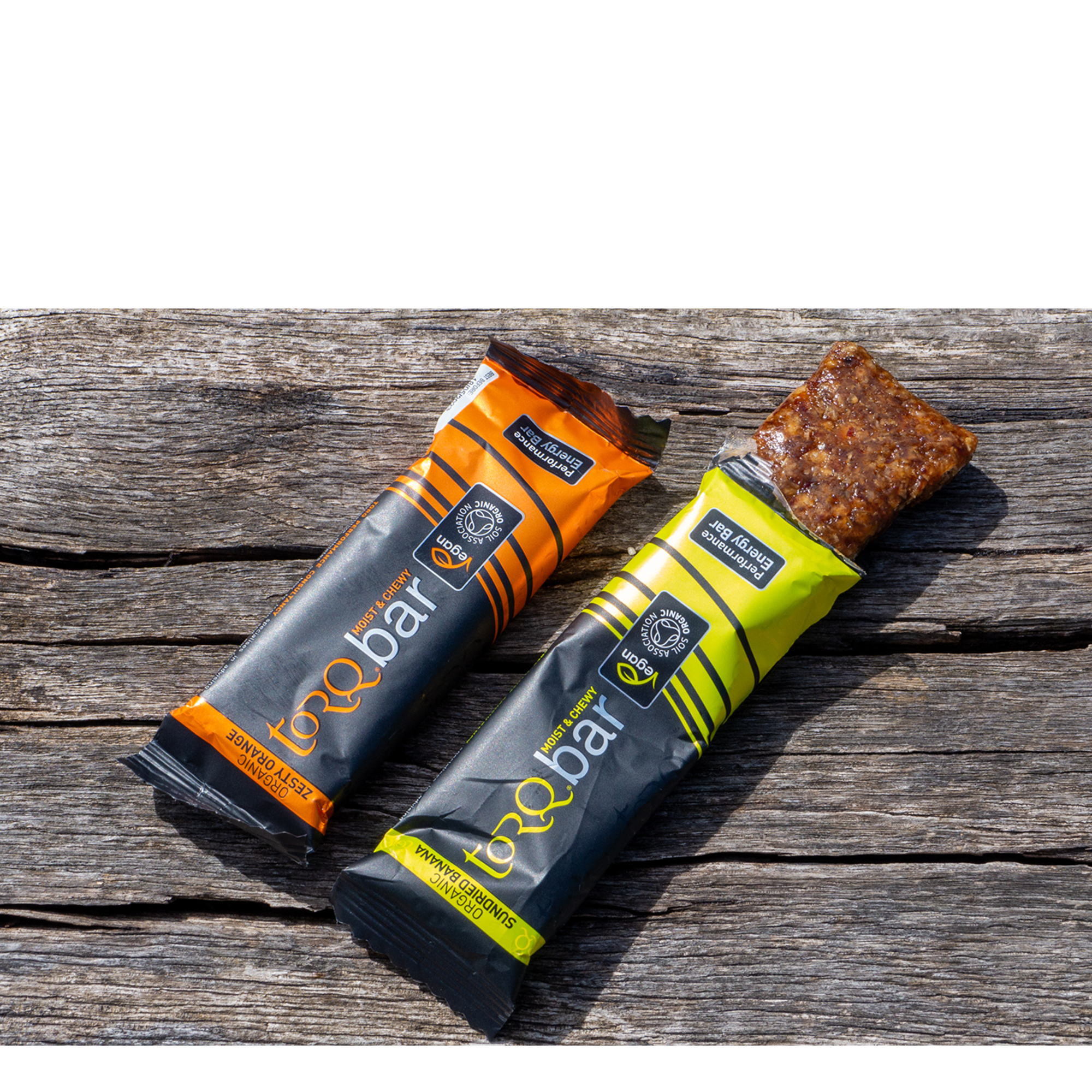 A pair of Torq energy bars on a wooden bench