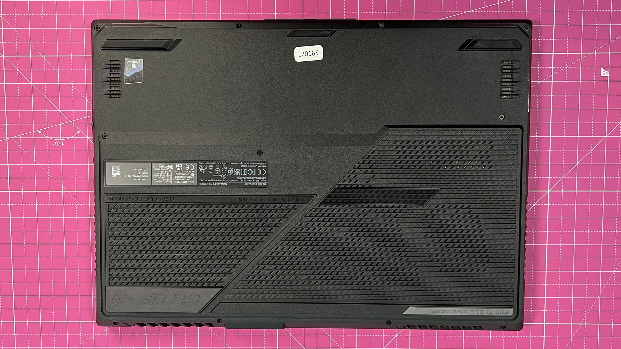 An Asus ROG Strix Scar 17 (2023) on a desk with a pink desk mat