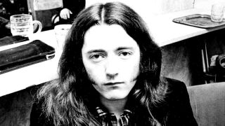 Rory Gallagher posing for a photograph in the early 1970s