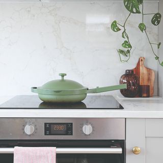 A kitchen hob with a sage green Always Pan