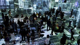 A mass of people converge on a Brooklyn projection mapping exhibit brought to life by Green Hippo. 