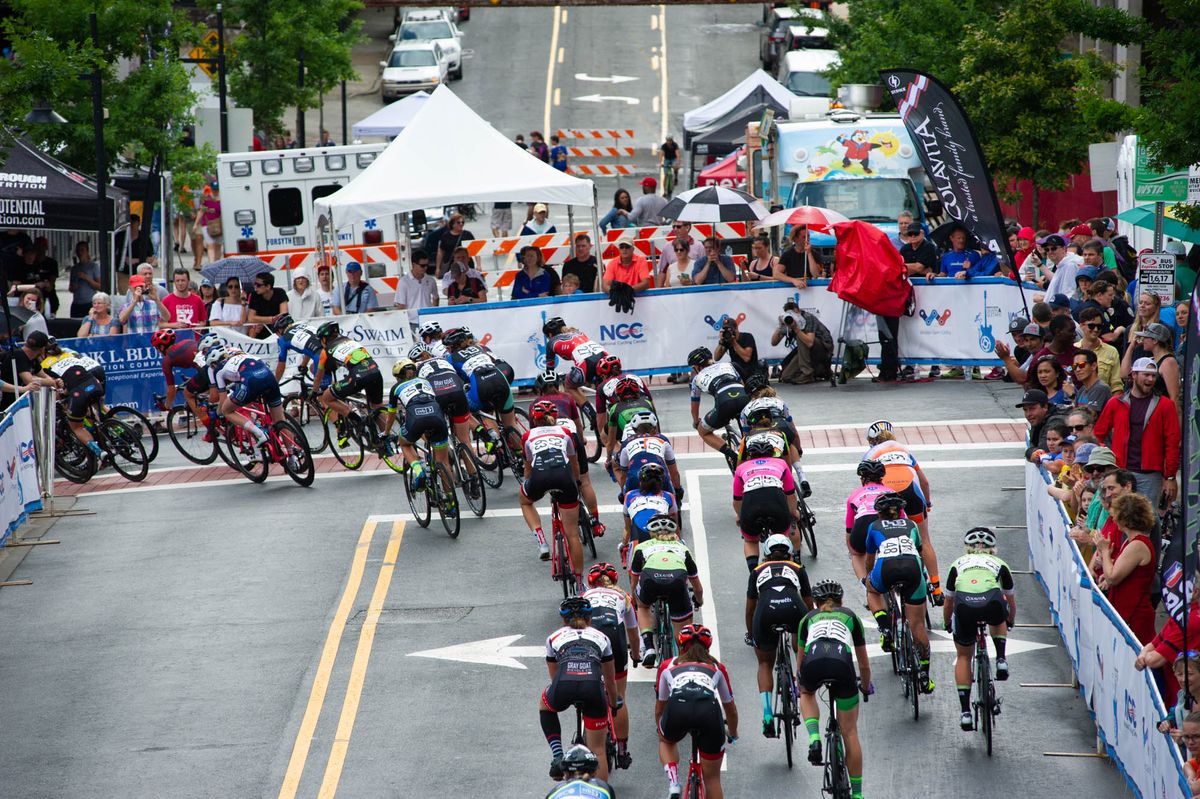Riders hit the slippery first turn during todays criterium