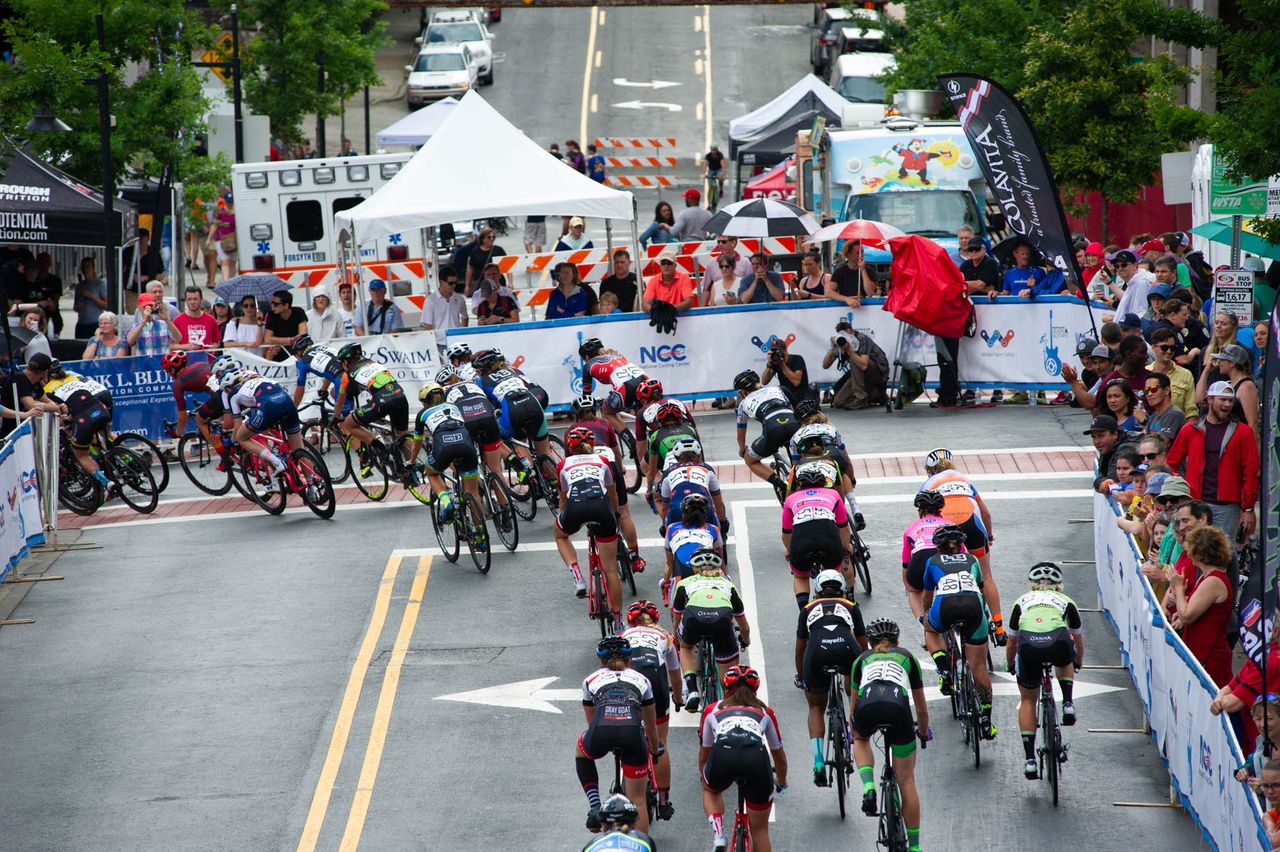 Riders hit the slippery first turn during todays criterium