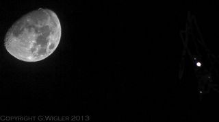Skywatcher Greg Wigler captured this photo of Jupiter near the moon on Jan. 21, 2013 during an extreme close encounter. The image also shows two Jovian moons and a star.