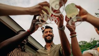 group of friends toasting with cocktails