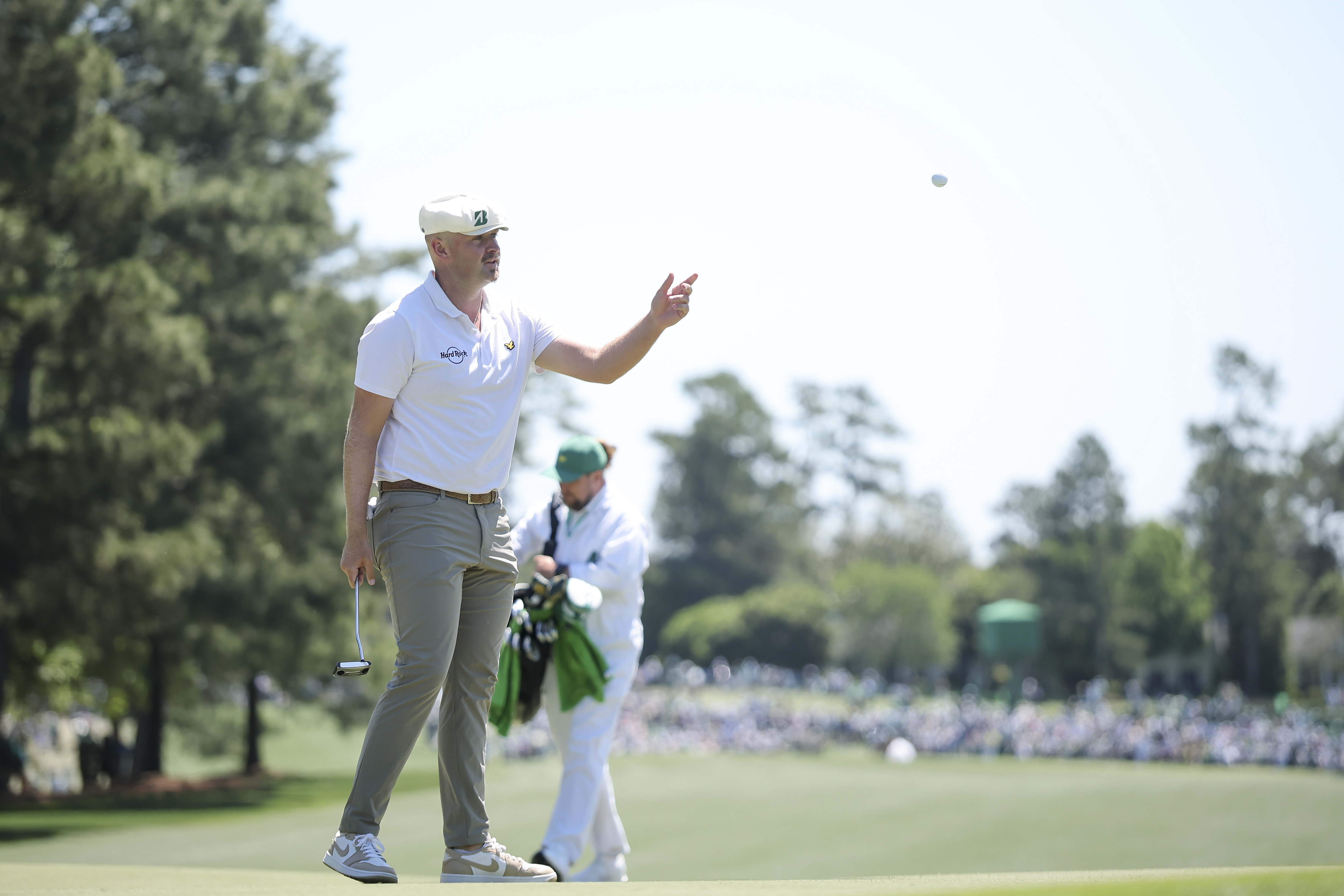Harry Hall tosses his ball on the first green during the first round of the 2026 Masters Tournament at Augusta National Golf Club