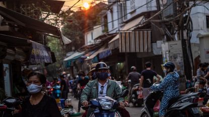 People wearing face masks to stop the spread of Covid in Hanoi, Vietnam