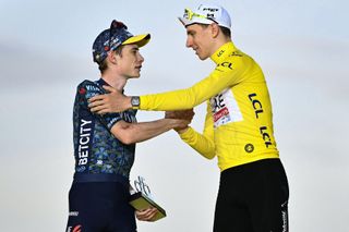 Jonas Vingegaard shakes hands with Tadej Pogačar on the podium of the 2024 Tour de France