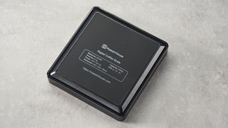 a black square coffee scale by Maestri House with a timer and a rechargeable battery