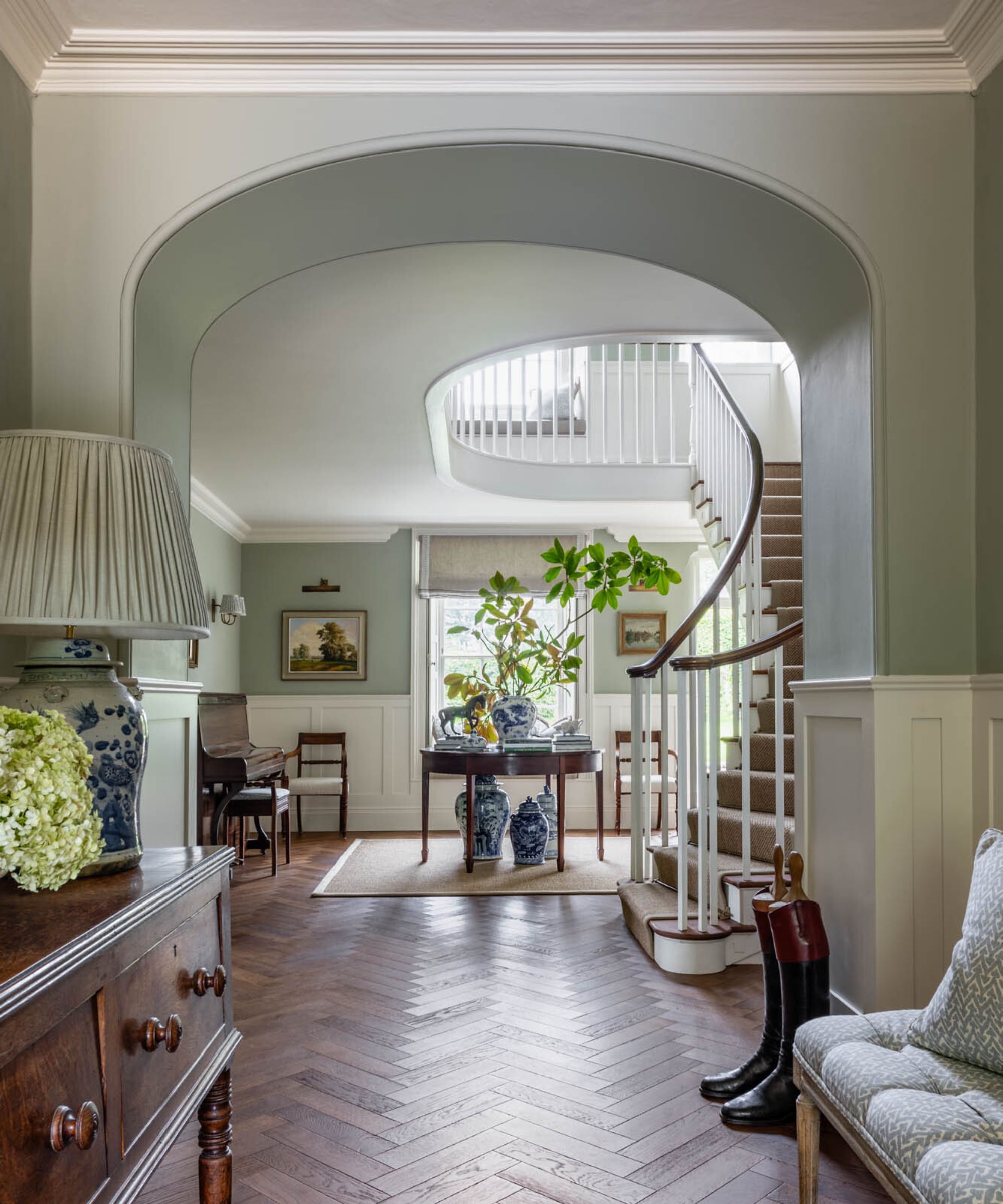 A grand hallway with pale blue walls