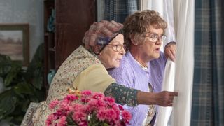 Winnie and Agnes peer out the window in MRs Brown's Boys season 4