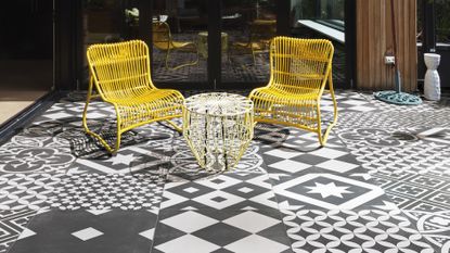 monochrome patchwork patio tiles and yellow seating