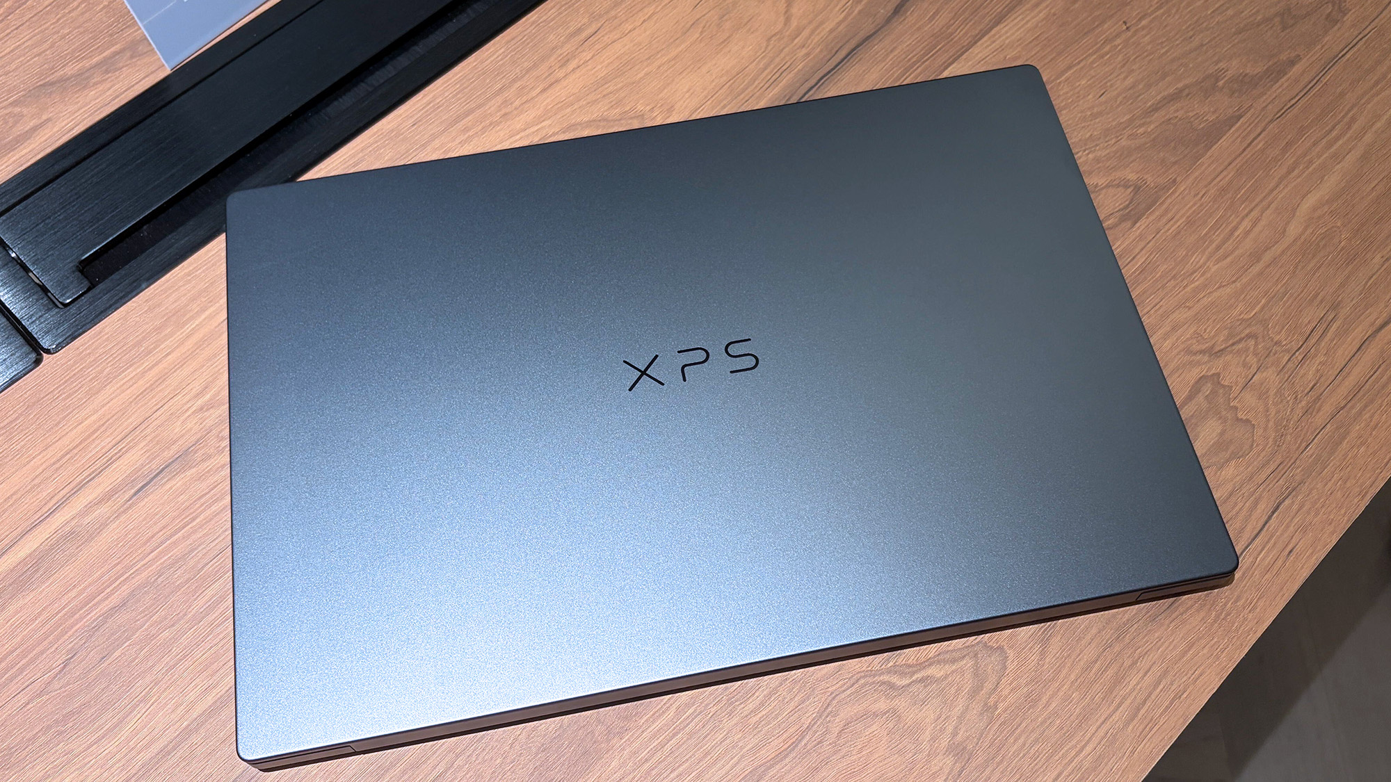 Dell XPS 16 Creator Edition laptop on a wooden display shelf at Computex 2026
