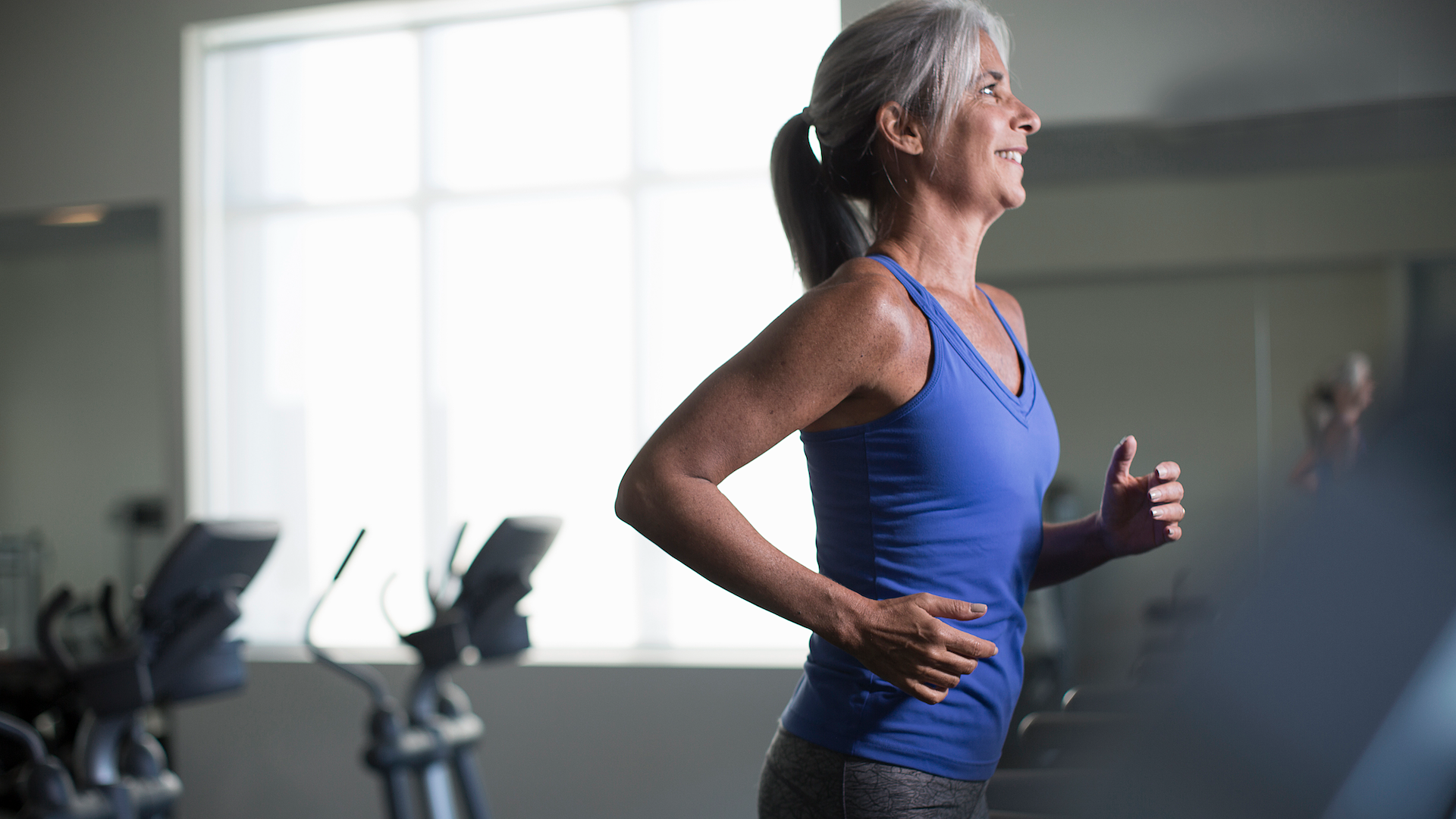 Woman running on treadmill in gym