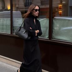 influencer with brown hair wearing The Row shoulder bag.