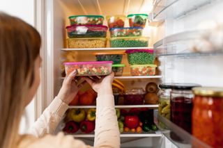 woman organizing a fridge