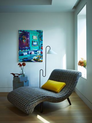 A bedroom corner with lounge chair