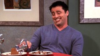 Joey (Matt LeBlanc) smiles with chocolate cake all over his face.