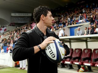 rory mcilroy with rugby ball