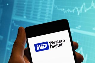 Western Digital logo appearing on a smartphone against a sky blue background