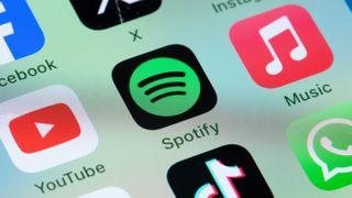 Spotify icon app on a phone screen, surrounded by Apple Music, YouTube, WhatsApp and TikTok apps