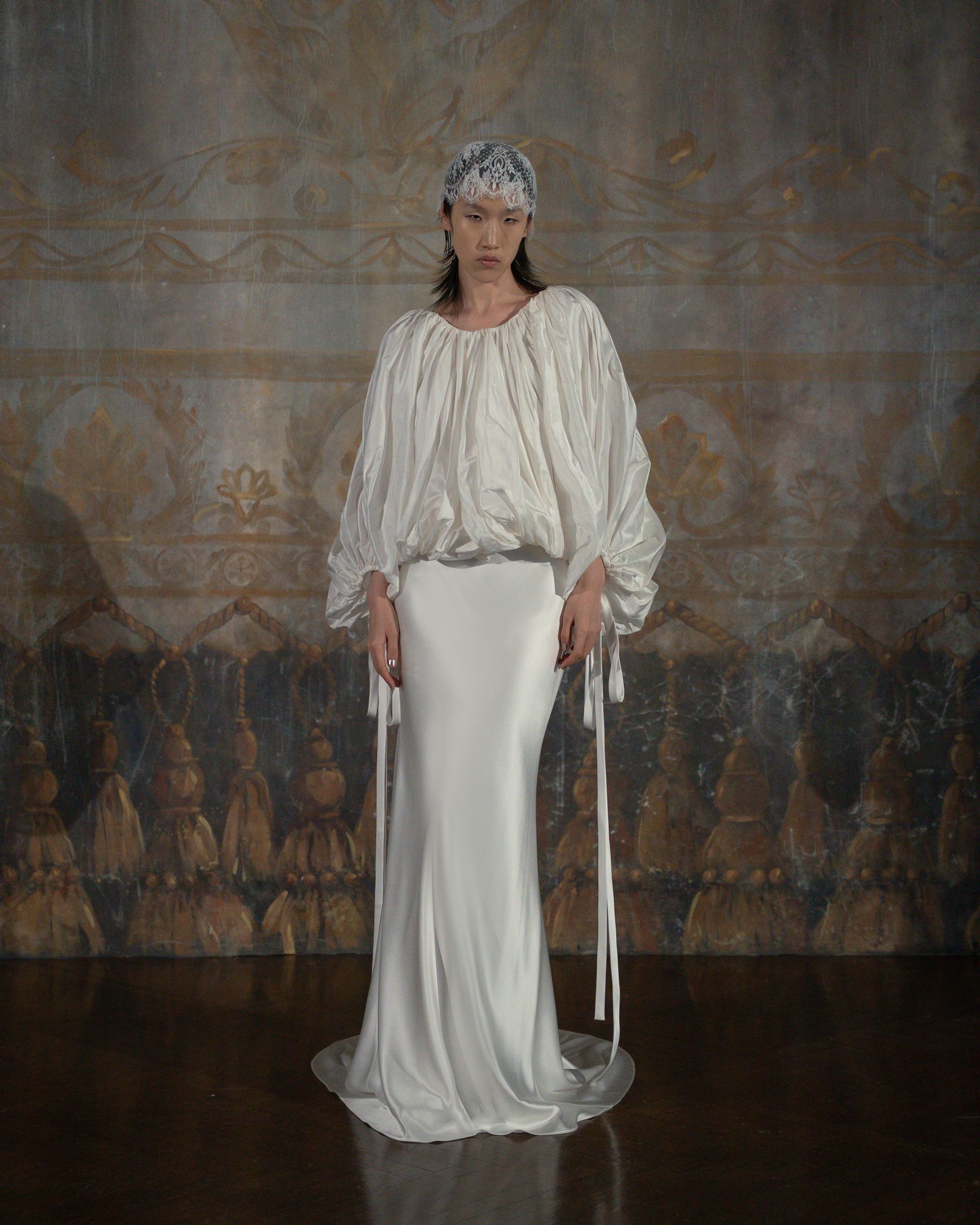 Woman wearing bridal hat, an emerging trend for 2026.
