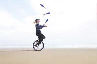 Woman juggling on a unicycle