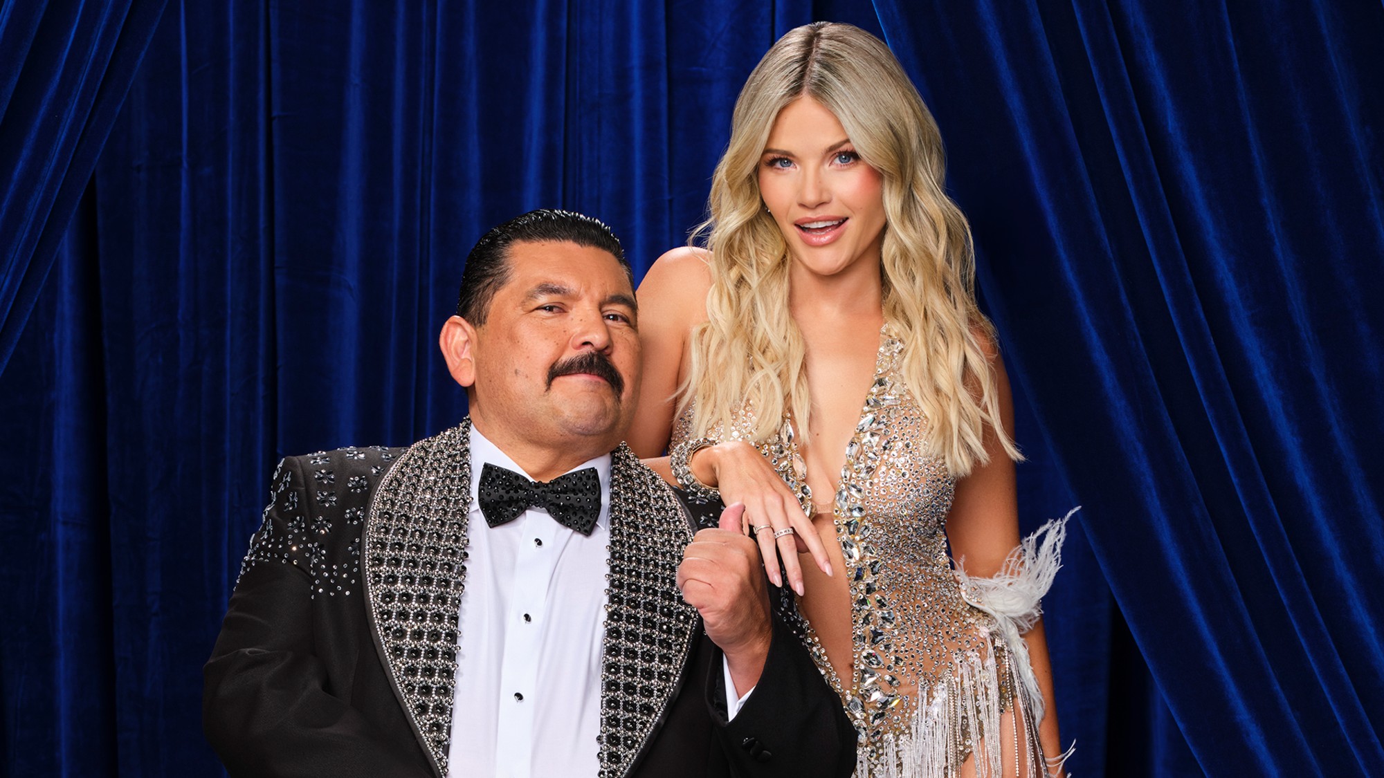 Guillermo Rodriguez and Witney Carson standing together in a photo fo Dancing with the Stars.